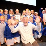 Michael Rosen celebrates with a school ontsage